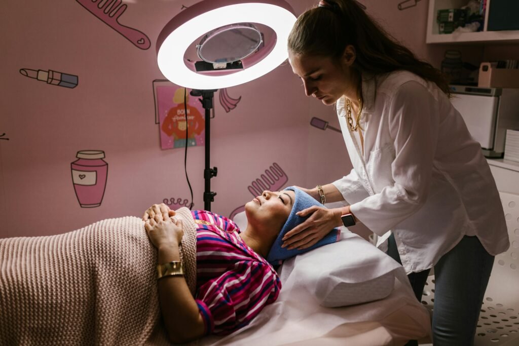 Home Woman receiving a relaxing facial treatment at a spa, promoting self-care and relaxation indoors.